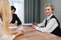 Portrait of middle-aged 50s businesswoman smiling looking at camera posing in boardroom during formal meeting, proud of Royalty Free Stock Photo