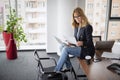 Portrait of middle aged smiling business woman using laptop at the office Royalty Free Stock Photo