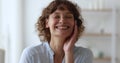 Portrait middle-aged woman standing indoor laughs over joke