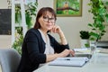 Portrait of middle aged woman working in home office Royalty Free Stock Photo