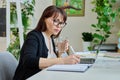 Portrait of middle aged woman working in home office Royalty Free Stock Photo