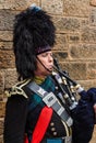 Portrait of a military dressed bagpiper playing the bagpipe