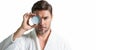 Portrait of millennial man applying cream on face skin. White  banner with copy space. Portrait of beauty man Royalty Free Stock Photo