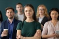 Portrait of millennial woman employee feeling part of corporate team