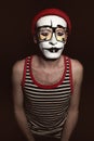 Portrait of mime wearing red hat and yellow eyeglasses Royalty Free Stock Photo