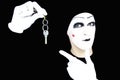 Portrait of the mime in white gloves with a key Royalty Free Stock Photo