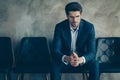 Portrait of minded frustrated collar sit in black chair have done serious mistake wait for his boss arguing sit chair