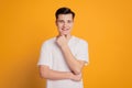 Portrait of minded happy young man dreaming isolated over yellow background Royalty Free Stock Photo