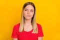 Portrait of minded smart girl look interested empty space contemplate ponder isolated on yellow color background Royalty Free Stock Photo