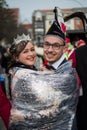 Portrait of miss and mister carnival wrapped in plastic film in the street