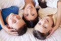 Portrait of a mixed race family in bed together. Mother with her adoptive sons. Young mother relaxing with her children Royalty Free Stock Photo