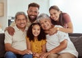 Portrait of mixed race family with child enjoying weekend in living room at home. Adorable smiling hispanic girl bonding Royalty Free Stock Photo