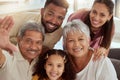 Portrait of mixed race family with child taking selfies in living room at home. Adorable smiling hispanic girl bonding Royalty Free Stock Photo