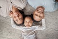 Portrait of a mixed race family of three relaxing on the lounge floor at home. Loving black family being affectionate on Royalty Free Stock Photo