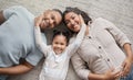 Portrait of a mixed race family of three relaxing on the lounge floor at home. Loving black family being affectionate on Royalty Free Stock Photo