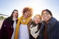 Portrait of Mixed race group of happy friends looking at camera and having fun in winter clothes Royalty Free Stock Photo