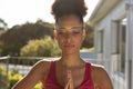 Portrait of mixed race woman exercising practicing yoga on a terrace