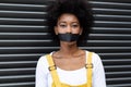 Portrait of mixed race woman having black tape on mouth