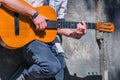 Portrait of mle musician playing the guitar outdoors