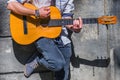 Portrait of mle musician playing the guitar outdoors. Horizontal image