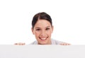 Portrait, mockup board and woman peeking over in studio isolated on a white background. Face, poster and happy female