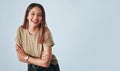 Portrait, mockup and laughter with an arms crossed woman in studio having fun on a gray background. Comic, comedy and