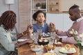 Modern African American Family Praying at Dinner Table on Easter Royalty Free Stock Photo