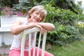 Portrait of a beautiful, happy and smart grandmother sitting on the chair outdoor