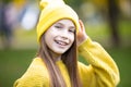 Portrait of modern happy teen girl with dental braces dressed in yellow clothes in park. Pretty teenage girl wearing Royalty Free Stock Photo