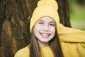 Portrait of modern happy teen girl with dental braces dressed in yellow clothes in park. Pretty teenage girl wearing