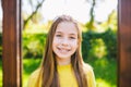 Portrait of modern happy teen girl with dental braces dressed in yellow clothes in park. Pretty teenage girl wearing Royalty Free Stock Photo