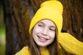 Portrait of modern happy teen girl with dental braces dressed in yellow clothes in park. Pretty teenage girl wearing Royalty Free Stock Photo