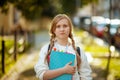 Portrait of modern pupil in white sweatshirt outdoors in city