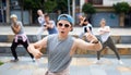 Modern teenager performing street dance with group