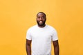 Portrait of a modern young black man smiling standing isolated yellow background Royalty Free Stock Photo