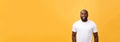 Portrait of a modern young black man smiling standing isolated yellow background Royalty Free Stock Photo