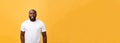 Portrait of a modern young black man smiling standing isolated yellow background Royalty Free Stock Photo