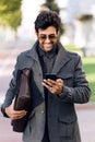 Modern young man using his mobile phone in the street. Royalty Free Stock Photo