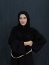 Portrait of modern young muslim woman in black abaya