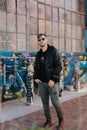 Portrait of Modern Young Person Hipster Guy Standing Alone in Urban Street Covered Colorful Graffiti Alleyway Outside in the City Royalty Free Stock Photo