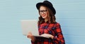 Portrait of modern young woman in casual working with laptop