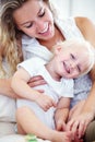 Portrait, mom and baby playing in home with smile, support and bonding for happy family wellness. Relax, mother and face Royalty Free Stock Photo