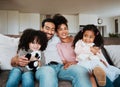 Portrait of mom, dad and kids on sofa, watching tv and happy family bonding together in living room. Smile, happiness Royalty Free Stock Photo