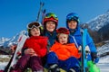 Portrait of a mom with kids sit in the snow wear ski outfit Royalty Free Stock Photo