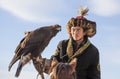 portrait of a mongolian eagle hunter with his eagle