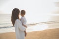 Portrait of mother and baby in the beach at sunset Royalty Free Stock Photo