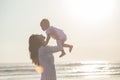 Portrait of mother and baby in the beach at sunset Royalty Free Stock Photo