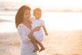 Portrait of mother and baby in the beach at sunset Royalty Free Stock Photo