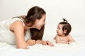 Portrait of mother and baby having fun, lie on white Royalty Free Stock Photo