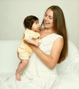 Portrait of mother and baby on white, yellow toned Royalty Free Stock Photo